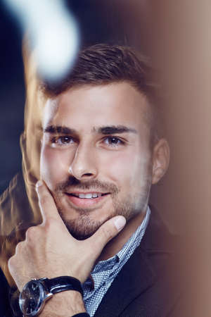 Portrait of casual man over dark background.の写真素材