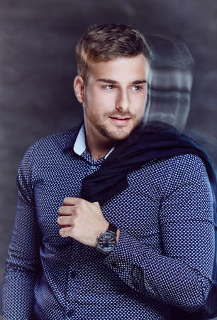 Portrait of casual man over dark background.の写真素材