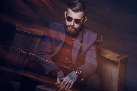 Bearded man in a suit and sunglasses.の写真素材