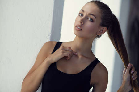 Close up portrait of slim young woman with long brown hair.の写真素材