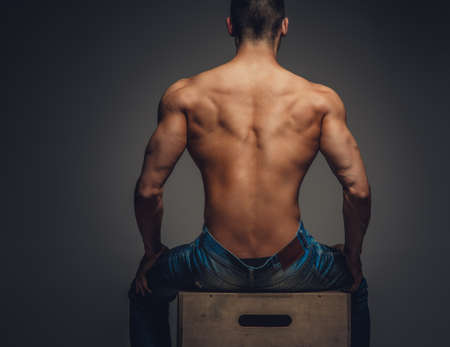 Man's back isolated on a grey background.の写真素材