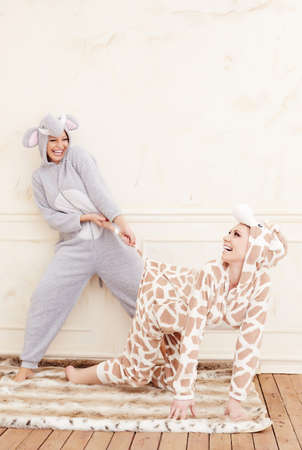 Two cute girls in pajamas having fun.の写真素材