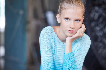Blue eyes girl in a blue casual sweater.
