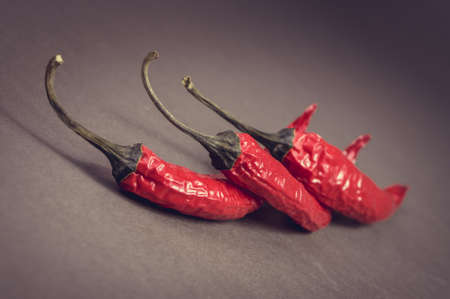 Three red hot chilli peppers.の写真素材