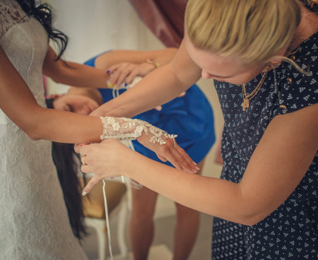 Bride and two woman assistants in a wedding shop.の写真素材