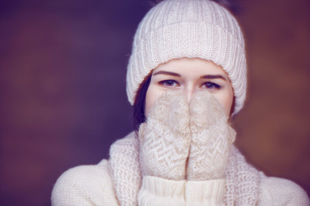 Portrait of a girl in a white sweater and winter hat.の写真素材