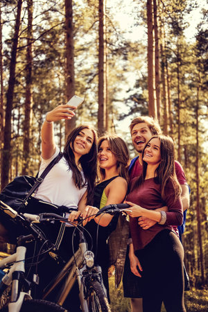 Group of friends relaxing in a park after bicycle riding.