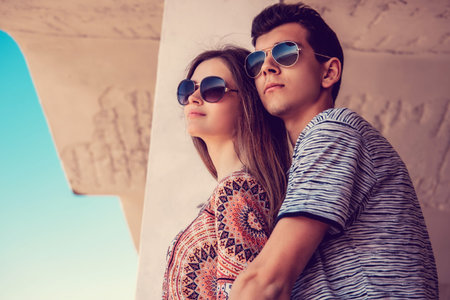 Loving couple posing under blue sky.の写真素材