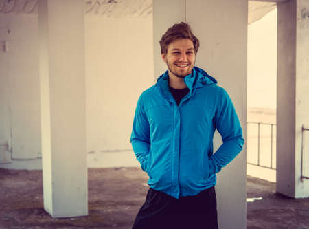 Portrait of sporty man in a blue jacket.の写真素材