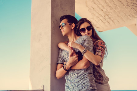 Lovely couple posing over blue sky on background.の写真素材