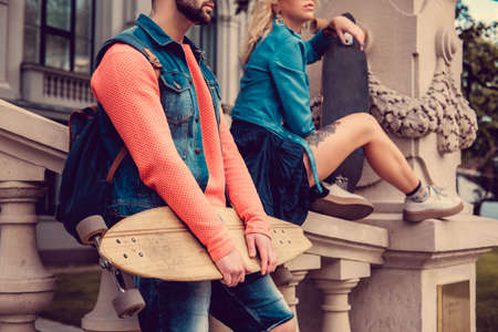 Casual longboarders posing in a town in natural light.の写真素材