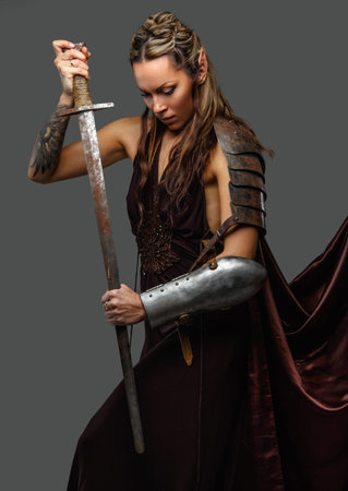 Elf woman warrior with sword isolated on a grey background.の写真素材