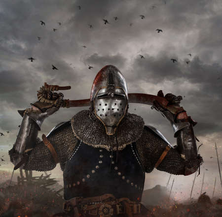 Knight with sword in battlefield with dark clouds on background.の写真素材