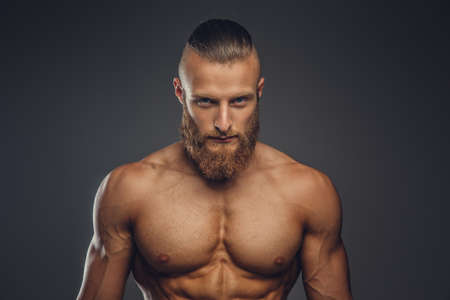 Shirtless sporty bearded male isolated on a grey background.の写真素材