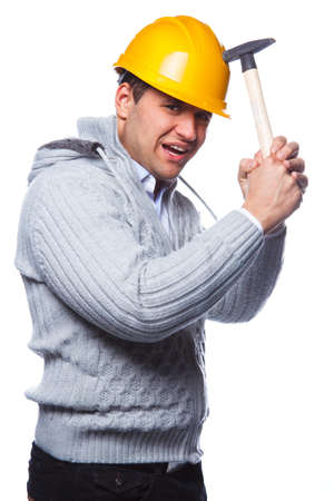 Male in yellow safe helmet holding hummer. Isolated on a white background.の写真素材