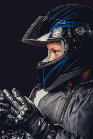 Portrait of female in motorcycle safety costume and black helmet.の写真素材