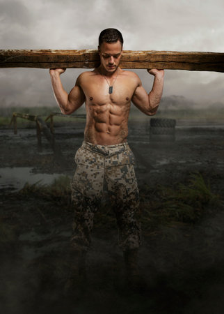 Shirtless soldier with wooden timber in a swampland.