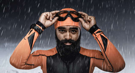 Portrait of bearded scuba diver under rain drops over snow mountains background.の写真素材
