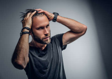 Studio portrait of fashionable modern male in grey t shirt.の写真素材