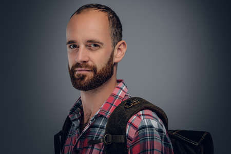 Studio portrait of bearded male in a shirt with backpack.の写真素材