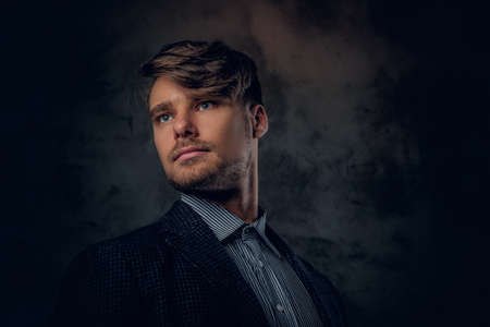 Studio portrait of modern, stylish male on glance grey background.の写真素材