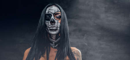 Day of the dead. Tattooed female with sugar skull make up.の写真素材