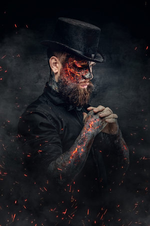A man with burning face and arm in fire sparks.