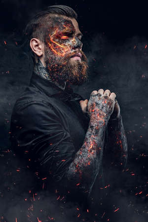 Close up portrait of bearded halloween hipster which is on fire.の写真素材