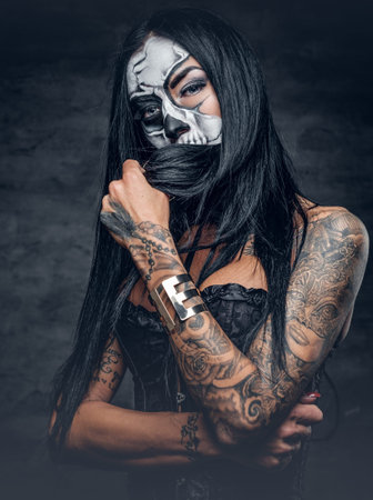 Day of the dead. Tattooed female with sugar skull make up.の写真素材