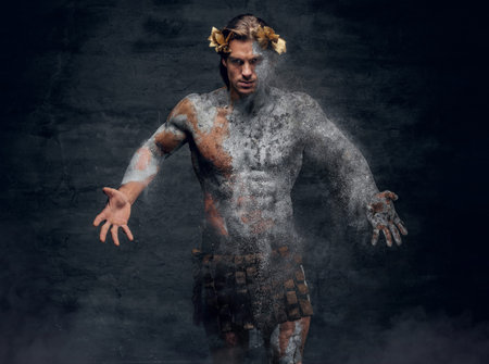 Ancient crumbling statue of athletic brutal male with half stone and natural body.の写真素材