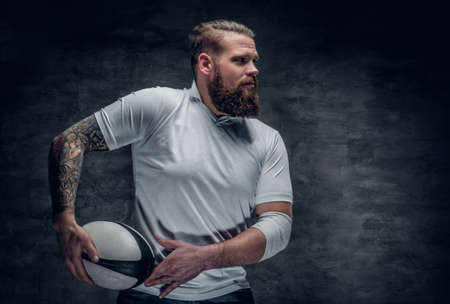 Brutal bearded rugby player in action of the game.の写真素材