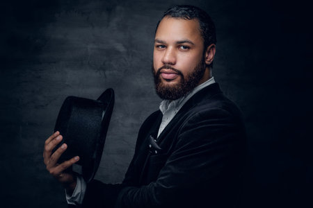 Bearded black man wearing a suit and a felt hat.