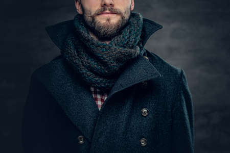 Handsome bearded male wearing a wool jacket and a scarf.の写真素材