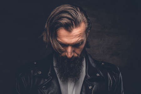 Studio portrait of stylish bearded male in black leather jacket.の写真素材