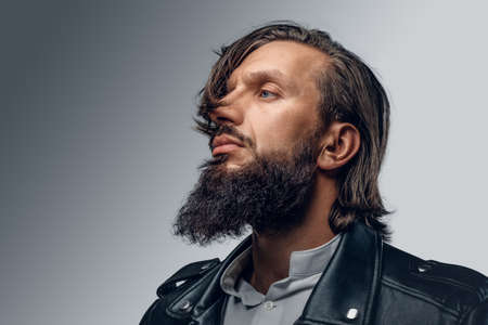 Studio portrait of stylish bearded male in black leather jacket.の写真素材