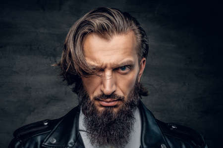 Studio portrait of stylish bearded male in black leather jacket.の写真素材