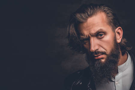 Studio portrait of stylish bearded male in black leather jacket.の写真素材
