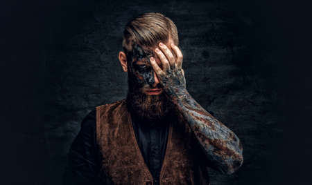Portrait of a scary bearded male with burning make.の写真素材
