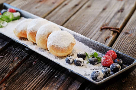 Homemade baked dessert bun rolls and some berries.