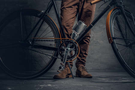 An authentic vintage single speed hipster's bicycle over grey wall background.の写真素材
