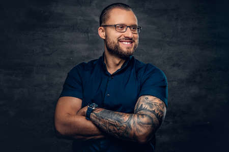 Portrait of bearded male in sunglasses with tattoo on his arm.の写真素材