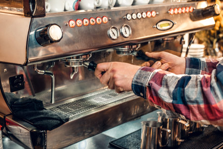 Close up image of a man making coffee in a professional coffee machine.の写真素材