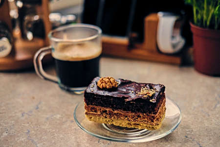 Sweet, delicious cake, herbs and cop of coffee on a table.の写真素材