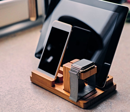 Bamboo wooden stand with smart watch, tablet PC and smart phone.