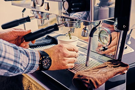 A man preparing cappuccino in a coffee shop.の写真素材