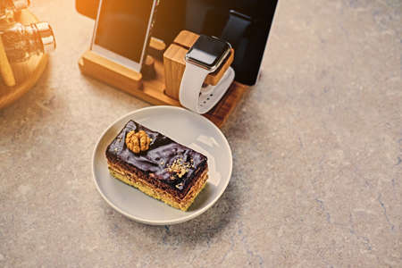 Delicious sweet cake on a table with smart watch, tablet PC and smart phone.の写真素材