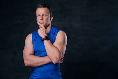 Studio portrait of attractive sporty male dressed in a blue sportswear.の写真素材
