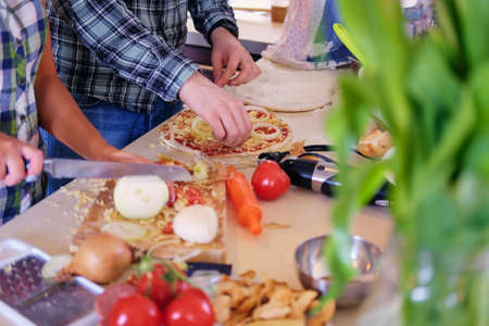 Image from the top view of couple makes pizza in a kitchen.の写真素材