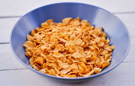 Corn flakes in a plate on a wooden desk.の写真素材