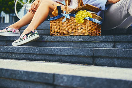 Close up image of picnic basket full of fruits, bread and wine.の写真素材